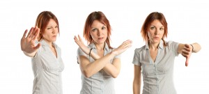 Young girl doing a bad signal over white background