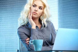 Blonde pretty business woman working at her office. She is very