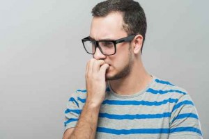 Closeup portrait of a nerdy young guy with glasses