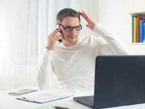Portrait of young businessman scratching his head