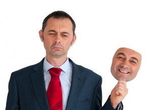 businessman concealing depression with a happy mask